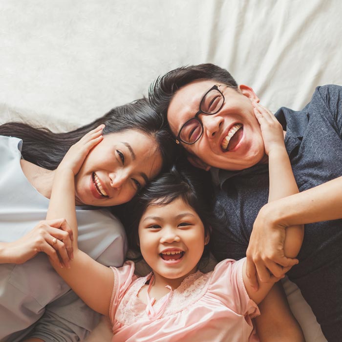 family of three laughing