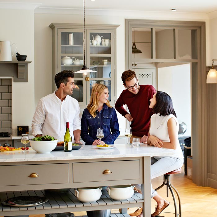 friends talking in kitchen