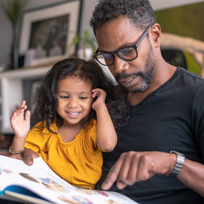 dad reading to his daughter