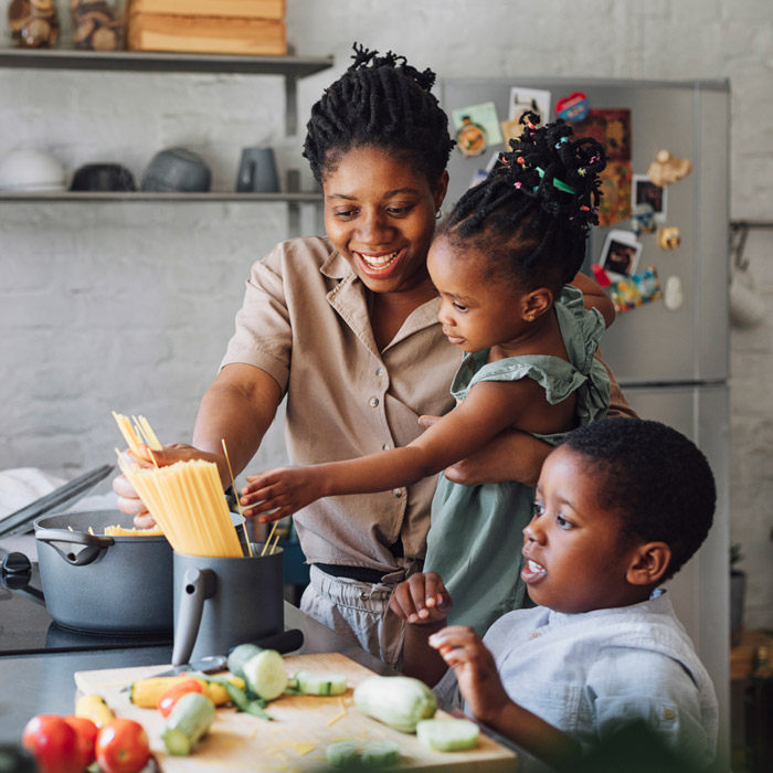 mom cooking with her two children