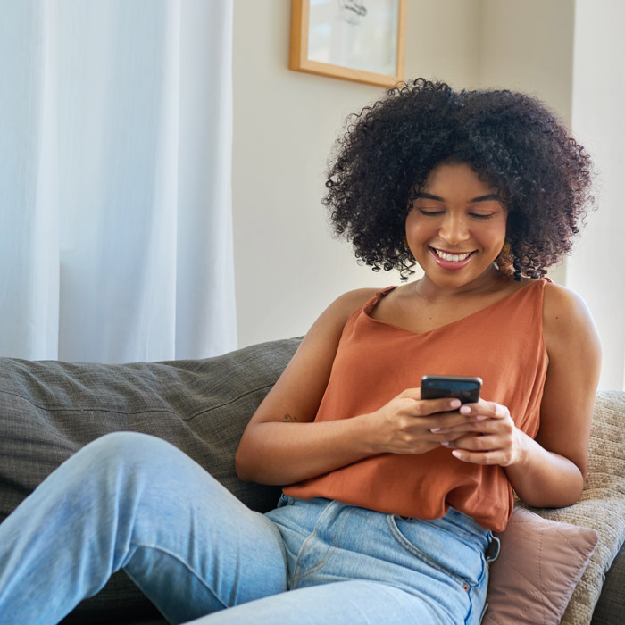 woman on her phone on the couch