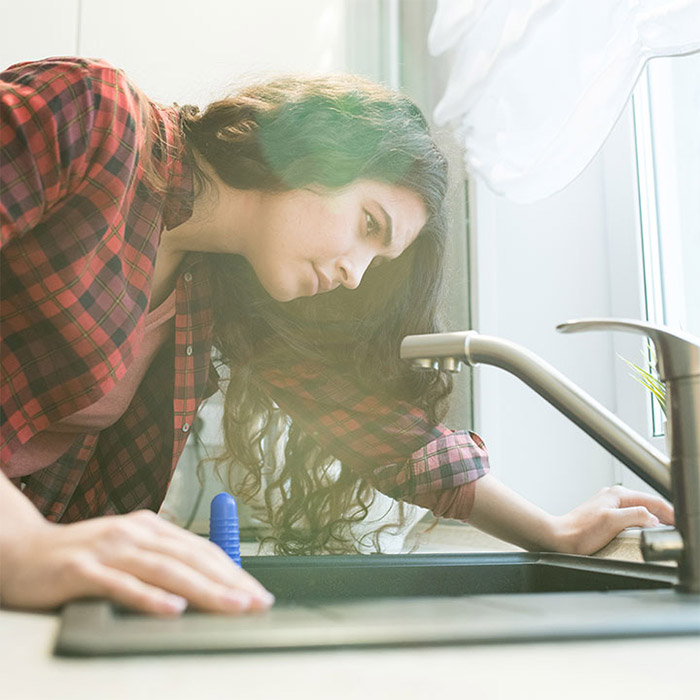 woman checking sink