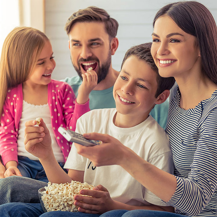family of four watching a movie together